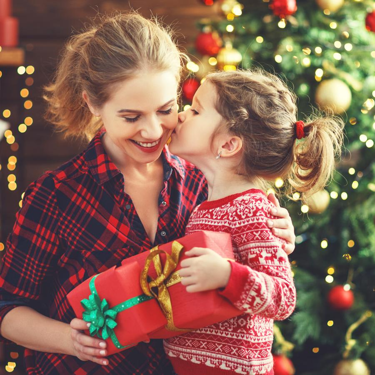 happy family mother and daughter giving christmas gift